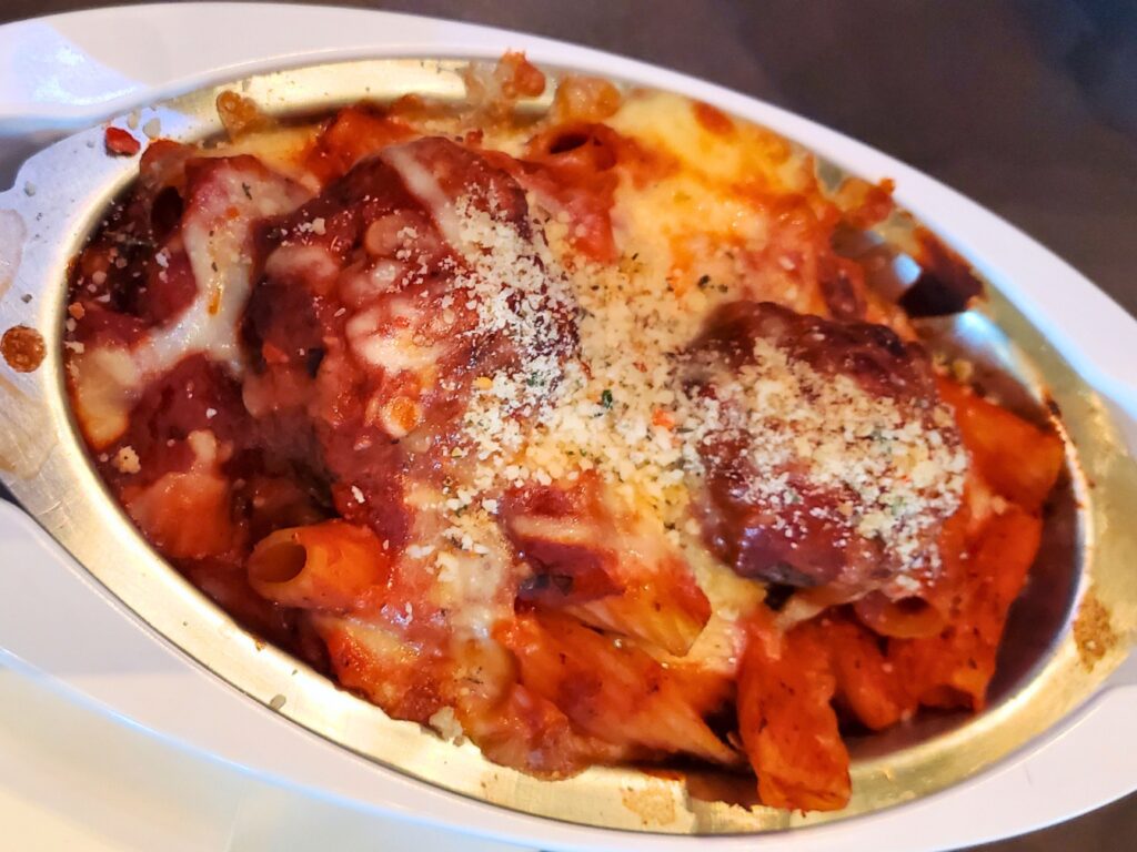 rigatoni with meatballs in a white bowl